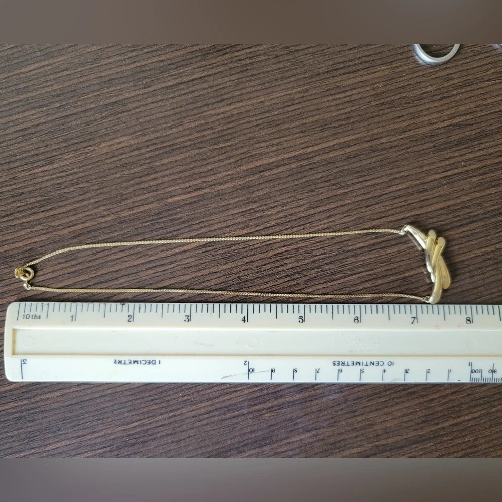 Golden necklace with modern pendant.